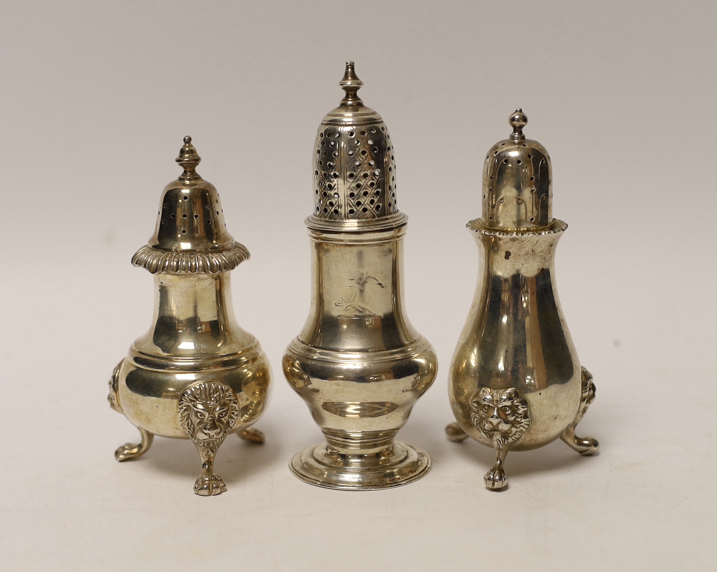 A George III silver baluster pepperette, London, 1763, 12.7cm, together with two modern silver pepperettes.